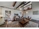 Airy living room featuring wood beams, high ceilings, a sliding door and a pass through at 4068 S Atchison Way # 301, Aurora, CO 80014