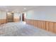 Spacious finished basement area with plush carpet, storage and wood paneling offers versatile living space at 7380 Tabor St, Arvada, CO 80005