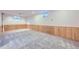 Finished basement area featuring neutral carpet and wood paneling, a versatile space for entertainment or relaxation at 7380 Tabor St, Arvada, CO 80005