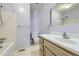 This charming bathroom features a shower-tub combo and a classic vanity with a sink, a great place to get ready! at 7380 Tabor St, Arvada, CO 80005