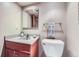 Cozy half bathroom features a granite vanity and decorative towel at 7380 Tabor St, Arvada, CO 80005