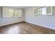 Simple bedroom features windows and hardwood floors at 7380 Tabor St, Arvada, CO 80005