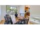Elegant dining room with a rustic wood table and contemporary black chairs at 7380 Tabor St, Arvada, CO 80005