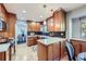 Charming kitchen featuring natural wood cabinets, stainless steel appliances, and ample counter space at 7380 Tabor St, Arvada, CO 80005