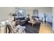 Bright living room with hardwood floors, a large window, and modern furnishings at 7380 Tabor St, Arvada, CO 80005