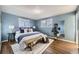 Serene primary bedroom boasts hardwood floors and bright windows at 7380 Tabor St, Arvada, CO 80005