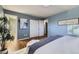 Spacious primary bedroom with hardwood floors and ensuite bathroom entrance at 7380 Tabor St, Arvada, CO 80005