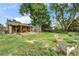 Enjoy this home's expansive backyard, featuring a covered patio ideal for entertaining, surrounded by mature trees at 1161 S Johnson Way, Lakewood, CO 80232