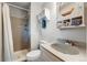 Cozy bathroom features a single sink, shelving, and shower with curtain at 1161 S Johnson Way, Lakewood, CO 80232