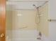 Clean bathroom features a shower-tub combo with showerhead, grab bar and tiled walls at 1161 S Johnson Way, Lakewood, CO 80232