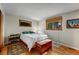 Comfortable bedroom features a wood floor, chest, and natural light from two windows at 1161 S Johnson Way, Lakewood, CO 80232
