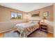 Neutral bedroom with classic features, including a floral comforter and hardwood trim at 1161 S Johnson Way, Lakewood, CO 80232