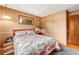 Neutral bedroom with classic features, including a floral comforter and hardwood trim at 1161 S Johnson Way, Lakewood, CO 80232