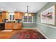 Bright dining area featuring hardwood floors, classic cabinets, and view of the backyard at 1161 S Johnson Way, Lakewood, CO 80232