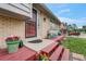 Charming home exterior with a welcoming front porch and colorful flower decorations at 1161 S Johnson Way, Lakewood, CO 80232