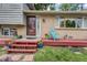Charming home featuring a cozy front porch, brick accents, and colorful planters at 1161 S Johnson Way, Lakewood, CO 80232