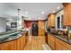 Spacious kitchen with granite countertops, stainless steel appliances, hardwood floors, and ample cabinet space at 1161 S Johnson Way, Lakewood, CO 80232