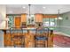 Cozy kitchen with wood cabinets, breakfast bar, and view to the backyard at 1161 S Johnson Way, Lakewood, CO 80232