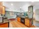 Open kitchen with modern appliances, granite countertops, and views to the living room at 1161 S Johnson Way, Lakewood, CO 80232