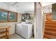 Bright laundry room with washer, dryer, and a window providing natural light at 1161 S Johnson Way, Lakewood, CO 80232