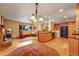 Spacious living room with a brick fireplace, hardwood flooring, and a large window at 1161 S Johnson Way, Lakewood, CO 80232