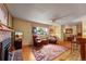 Cozy living room with a brick fireplace, hardwood floors, and comfortable seating, perfect for relaxing at 1161 S Johnson Way, Lakewood, CO 80232