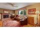 This well-lit living room features a brick fireplace, hardwood floors, and ample seating for Gathering and guests at 1161 S Johnson Way, Lakewood, CO 80232