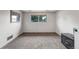 Bright living space with neutral carpet, large window, and modern entertainment center at 1161 S Johnson Way, Lakewood, CO 80232