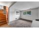 Finished basement with neutral carpet, large window, and convenient access to the upper level at 1161 S Johnson Way, Lakewood, CO 80232
