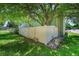 Lush green backyard with mature trees, white privacy fence, and tidy rock landscaping for serene outdoor enjoyment at 1711 Cato Cir # 21, Lafayette, CO 80026