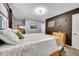 Bright bedroom featuring a bed with white bedding, neutral walls, carpet, and brown accent wall at 1711 Cato Cir # 21, Lafayette, CO 80026