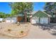 Inviting townhome featuring a two-car garage, well-kept landscaping, and mature trees at 1711 Cato Cir # 21, Lafayette, CO 80026