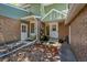 Charming townhome entrance with brick facade, green siding, and a small garden area at 1711 Cato Cir # 21, Lafayette, CO 80026