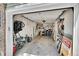 A spacious garage interior featuring a variety of tools, bikes, and recreational equipment, plus 