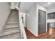 Hallway featuring a staircase, closet, and hardwood floors with a glimpse into the kitchen at 1711 Cato Cir # 21, Lafayette, CO 80026