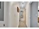 Hallway leading to a full bathroom with colorful shower curtain and a nearby closet at 1711 Cato Cir # 21, Lafayette, CO 80026