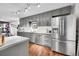 Updated kitchen boasts gray cabinetry, stainless steel appliances, and contemporary lighting at 1711 Cato Cir # 21, Lafayette, CO 80026