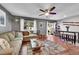 Cozy living room featuring a large window, sliding glass door, and ceiling fan at 1711 Cato Cir # 21, Lafayette, CO 80026