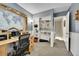 This is a home office with wooden desk, bookshelf, carpet, neutral walls, and a map above the desk at 1711 Cato Cir # 21, Lafayette, CO 80026