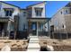 Two-story townhome with gray siding and stone accents at 6608 N Nepal Ct, Aurora, CO 80019