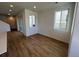 Bright living room with sliding glass doors and wood-look floors at 6608 N Nepal Ct, Aurora, CO 80019