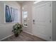 Bright entryway featuring light walls, wood floors, and an eye-catching piece of artwork to welcome guests at 21925 E 51St St, Aurora, CO 80019