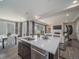 Open-concept kitchen featuring stainless steel appliances, a large island, and seamless flow into the living area at 21925 E 51St St, Aurora, CO 80019