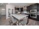 Well-equipped kitchen boasts dark cabinetry, modern appliances, and a spacious island with bar stool seating at 21925 E 51St St, Aurora, CO 80019