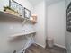 Functional laundry room with shelving, ironing board, and space-saving design at 21925 E 51St St, Aurora, CO 80019