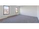 Bright bedroom with neutral carpeting and two large windows at 3124 W 9Th Avenue Pl, Broomfield, CO 80020