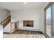 Dining area with brick fireplace, wood-look floors, and access to the outdoors at 3124 W 9Th Avenue Pl, Broomfield, CO 80020