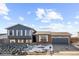 Ranch style home with gray siding, brick accents, and a two-car garage at 3124 W 9Th Avenue Pl, Broomfield, CO 80020