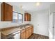 Galley style kitchen with wood cabinets and laminate countertops at 3124 W 9Th Avenue Pl, Broomfield, CO 80020