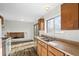 Eat-in kitchen with wood cabinets, laminate countertops, and a sliding glass door at 3124 W 9Th Avenue Pl, Broomfield, CO 80020